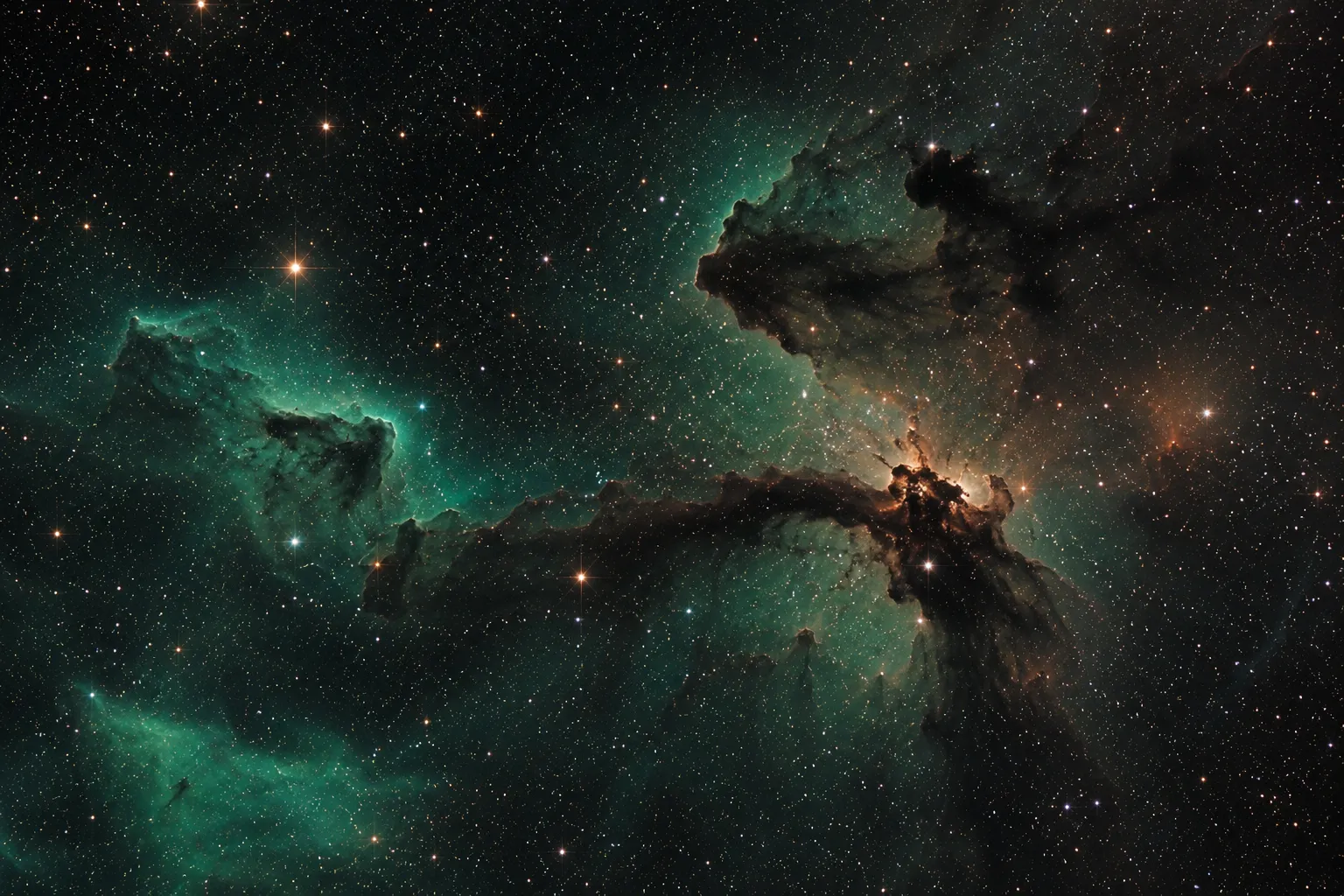 An emerald emission nebula in a warm starfield.